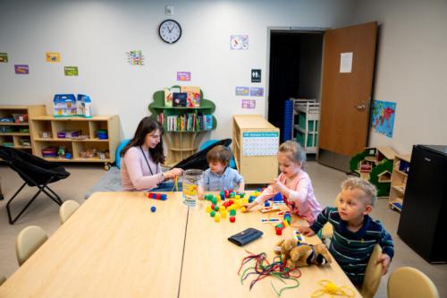 Children work with a staff member at Stepping Stones Tooele, a day care that shares a campus with Harris Housing and Switchpoint Tooele Community Resource Center in Tooele on Friday, May 24, 2024. (Photo by Spenser Heaps for Utah News Dispatch)