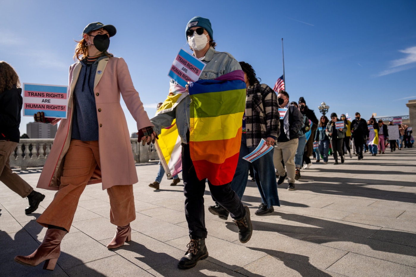 Meagan Bertelsen and Shannon march hand-in-hand as people rally in support of transgender rights at the Capitol in Salt Lake City on the first day of the legislative session, Tuesday, Jan. 21, 2025. (Photo by Spenser Heaps for Utah News Dispatch)