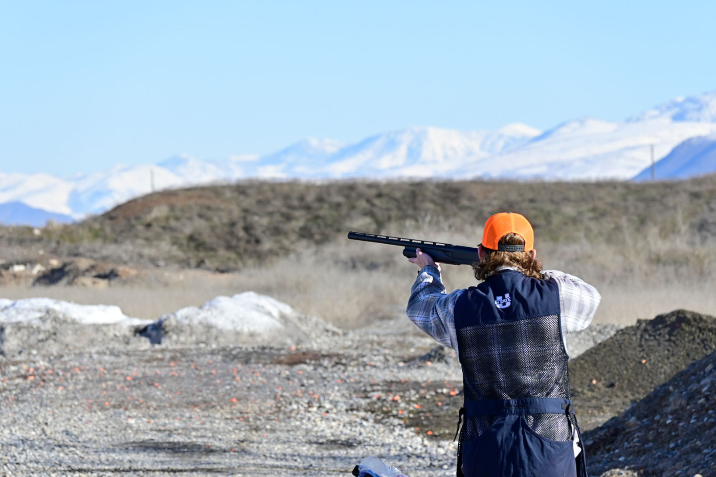 USU Shotgun Shooting Club member Chandler Wilson aims and shoots at a clay target 